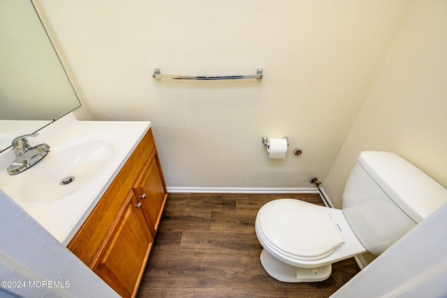 bathroom featuring vanity, wood-type flooring, and toilet