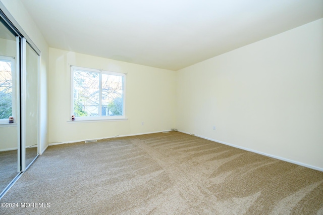 unfurnished bedroom with carpet floors and a closet