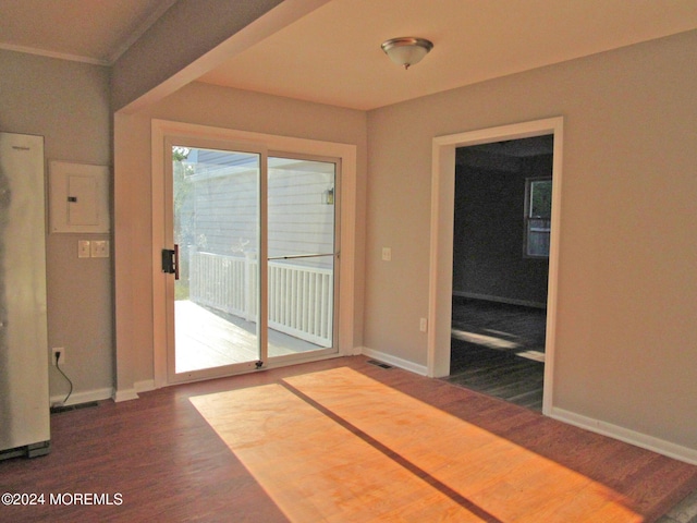 interior space featuring electric panel, crown molding, and dark hardwood / wood-style flooring