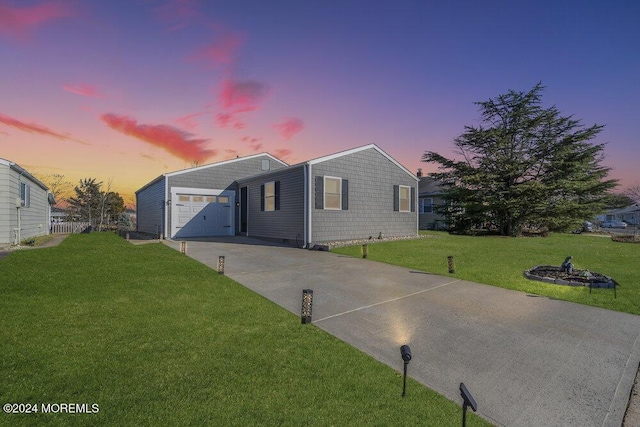 view of front of property with a lawn and a garage