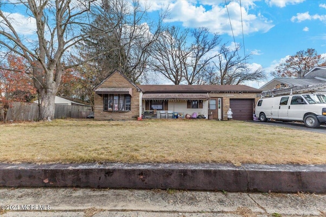 single story home with a garage and a front yard