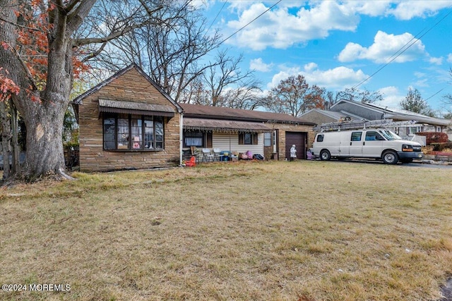 view of front of home featuring a garage and a front yard