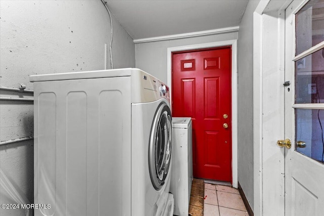 laundry area featuring light tile patterned floors and separate washer and dryer