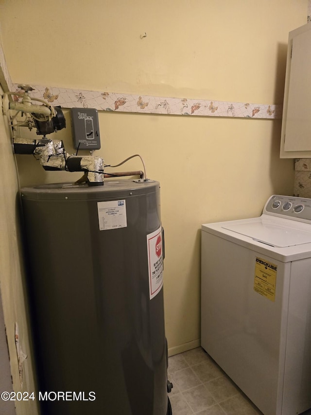 laundry area with cabinets, washer / dryer, and water heater