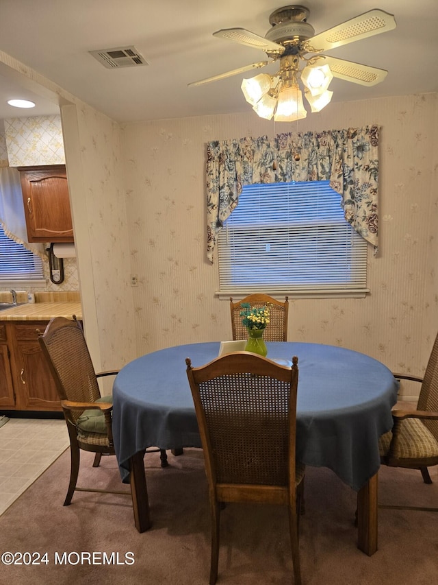 dining area featuring ceiling fan and light tile patterned floors