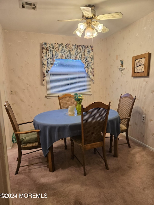 carpeted dining area featuring ceiling fan