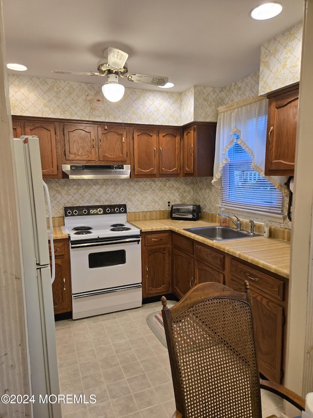 kitchen featuring ceiling fan, white appliances, sink, and tasteful backsplash