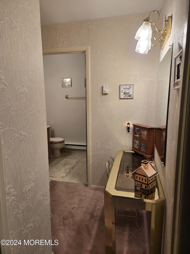 bathroom featuring toilet and a baseboard heating unit