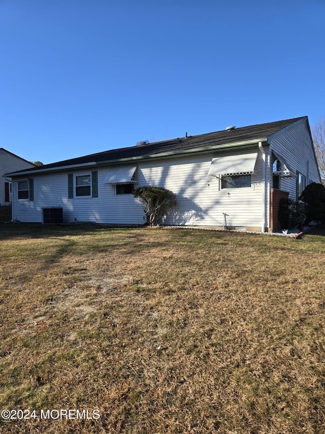 view of side of home featuring a lawn