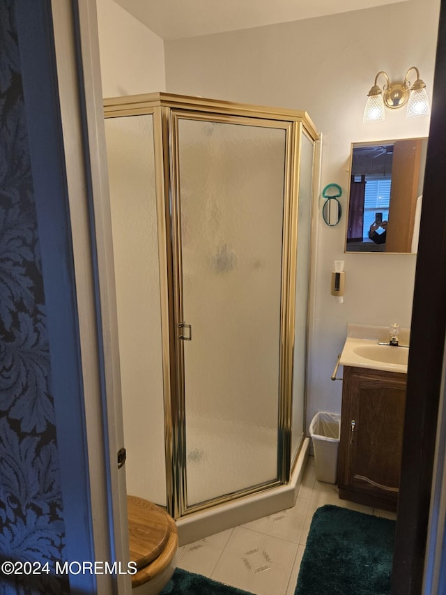 bathroom with vanity, toilet, and an enclosed shower