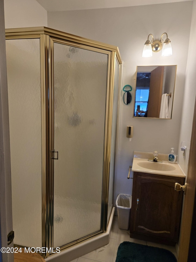 bathroom featuring vanity, tile patterned floors, and walk in shower