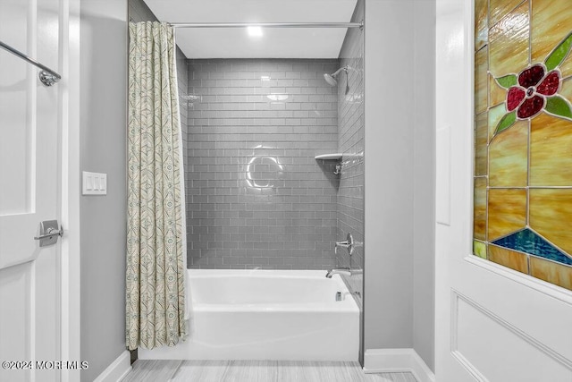 bathroom with shower / tub combo with curtain