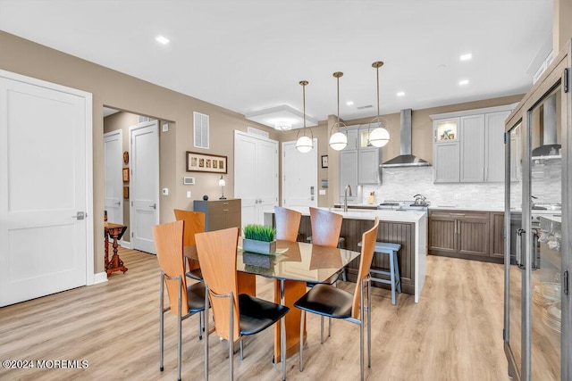 dining space featuring light hardwood / wood-style floors and sink