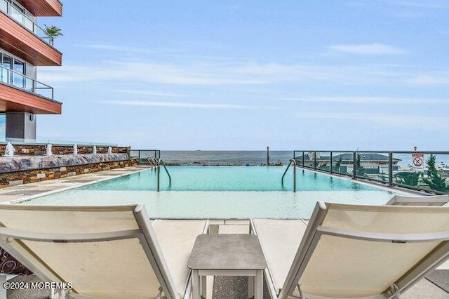 view of pool with a water view