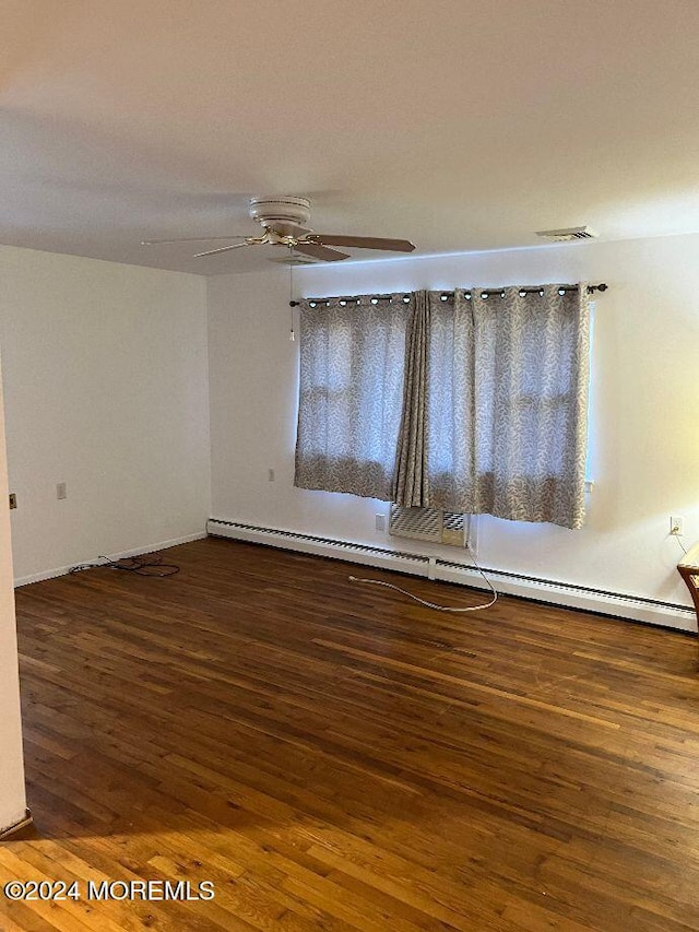 empty room featuring ceiling fan, wood-type flooring, and a baseboard radiator