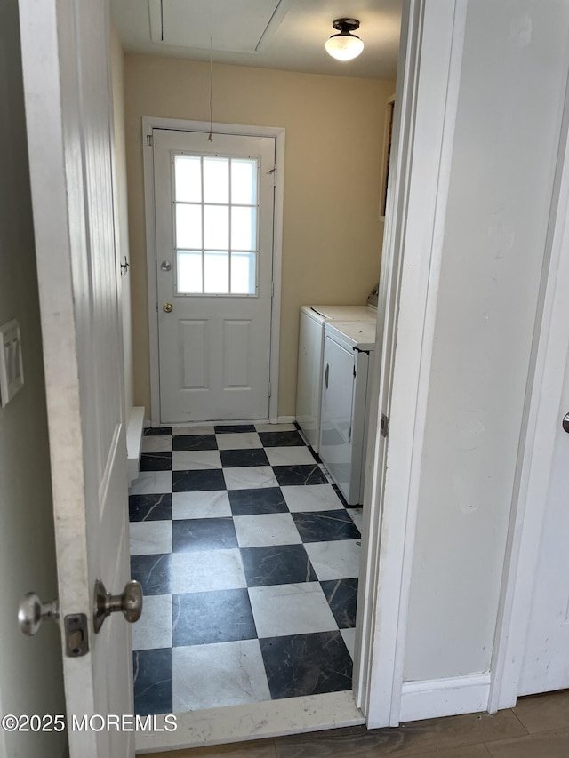 entryway with washing machine and clothes dryer and tile patterned floors