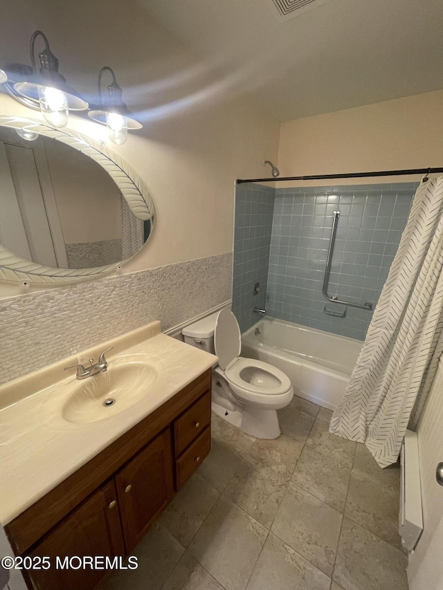 full bath with toilet, tile walls, vanity, wainscoting, and shower / bathtub combination with curtain