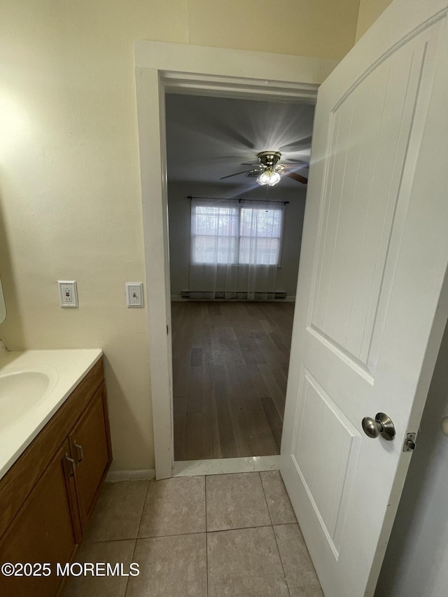 bathroom featuring ceiling fan, tile patterned flooring, and vanity