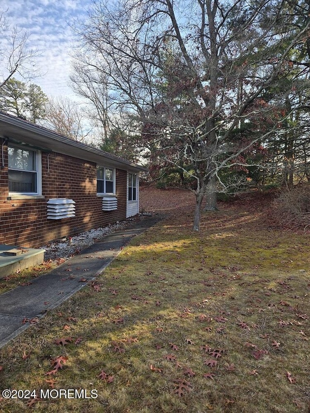 view of side of home featuring a yard