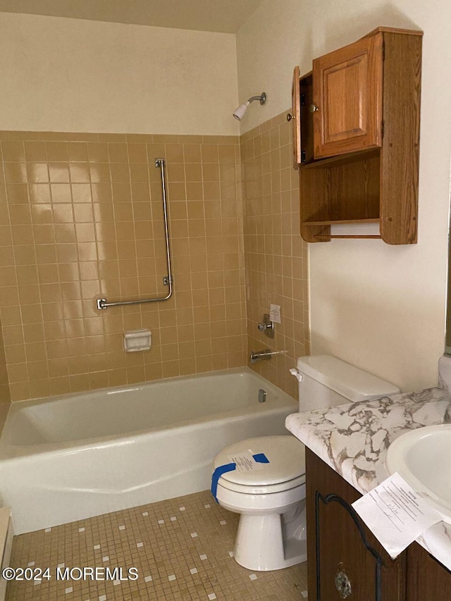 full bathroom with tile patterned floors, vanity, toilet, and tiled shower / bath combo