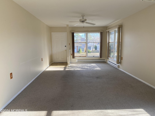 carpeted empty room featuring baseboard heating and ceiling fan