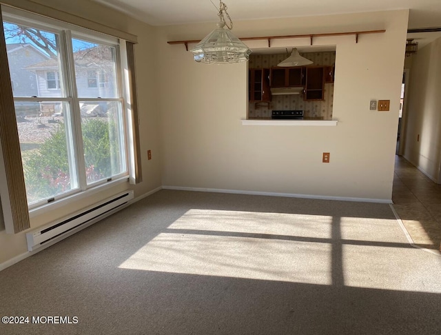 empty room featuring a chandelier, dark carpet, and a baseboard heating unit