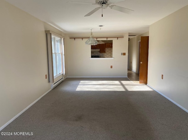 carpeted spare room featuring ceiling fan and baseboard heating