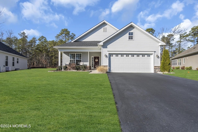 view of front of property with a front yard and a garage