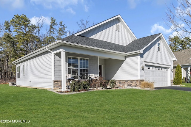 view of front of house with a front yard and a garage