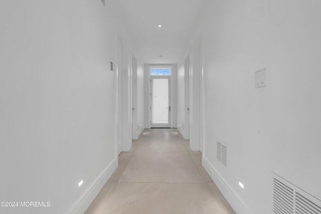 hallway with visible vents and baseboards