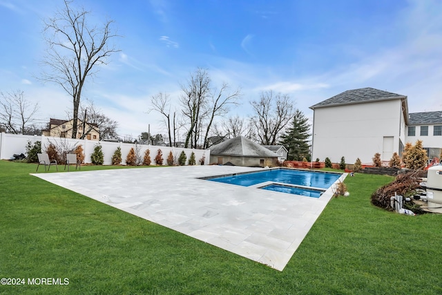 view of swimming pool featuring a patio area, a fenced backyard, a yard, and an in ground hot tub