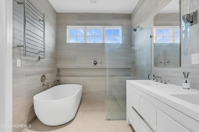 full bathroom featuring a walk in shower, a sink, tile walls, and radiator