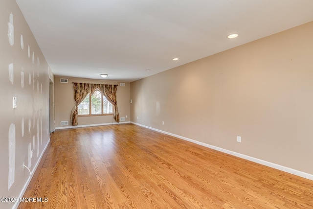 spare room with light hardwood / wood-style floors