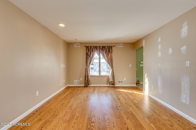 spare room with light wood-type flooring