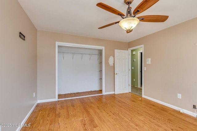 unfurnished bedroom with a closet, light hardwood / wood-style flooring, and ceiling fan