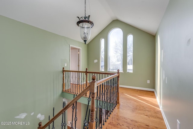 hall with light hardwood / wood-style floors and lofted ceiling