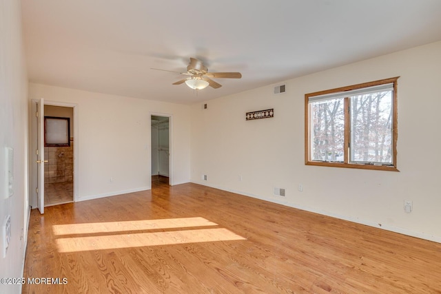 empty room featuring ceiling fan and light wood-type flooring