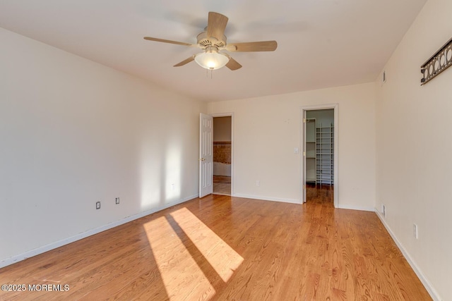 unfurnished room featuring light hardwood / wood-style flooring and ceiling fan