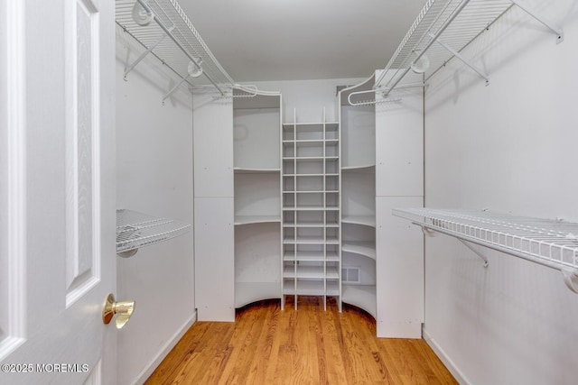 spacious closet featuring light hardwood / wood-style floors