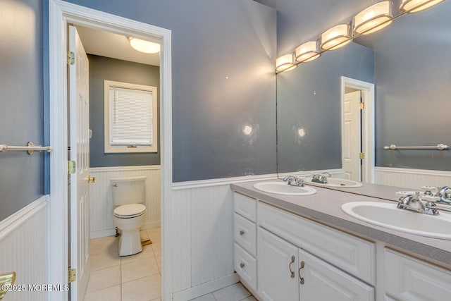 bathroom with tile patterned floors, vanity, and toilet