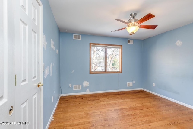 unfurnished room with light wood-type flooring and ceiling fan