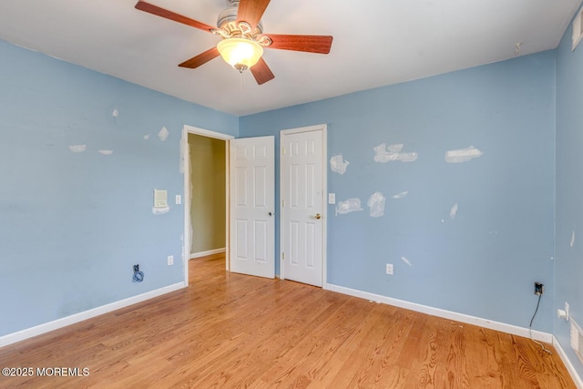 spare room featuring light hardwood / wood-style floors and ceiling fan