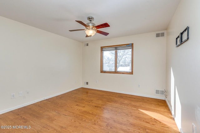 empty room with ceiling fan and light hardwood / wood-style floors