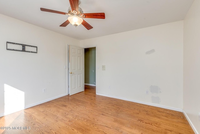 empty room with light wood-type flooring and ceiling fan