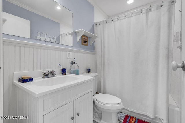 bathroom with vanity, wooden walls, toilet, and ornamental molding