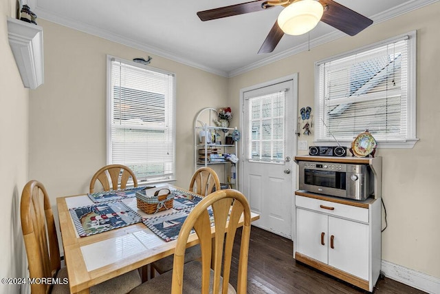 dining space with ceiling fan, crown molding, a healthy amount of sunlight, and dark hardwood / wood-style floors