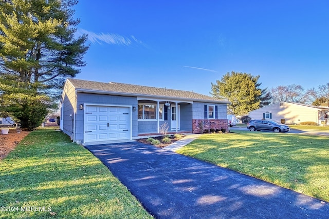 ranch-style home with a front lawn, covered porch, and a garage