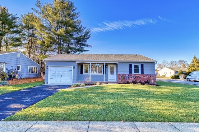 single story home with a porch, a garage, and a front yard