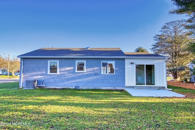 back of house with a patio area, central air condition unit, and a lawn