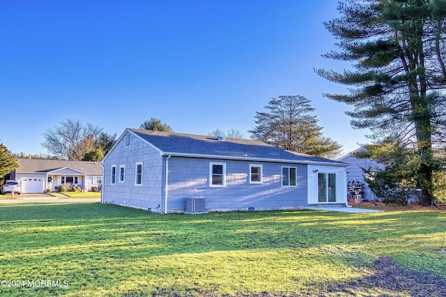 view of front facade featuring central AC unit, a garage, and a front lawn